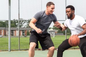 two men playing basketball as part of their new jersey sober living programs