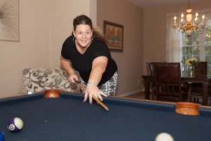 woman playing pool at sober living in Camden County NJ