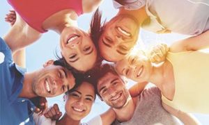 what to expect from sober living, looking up at several smiling people in a circle