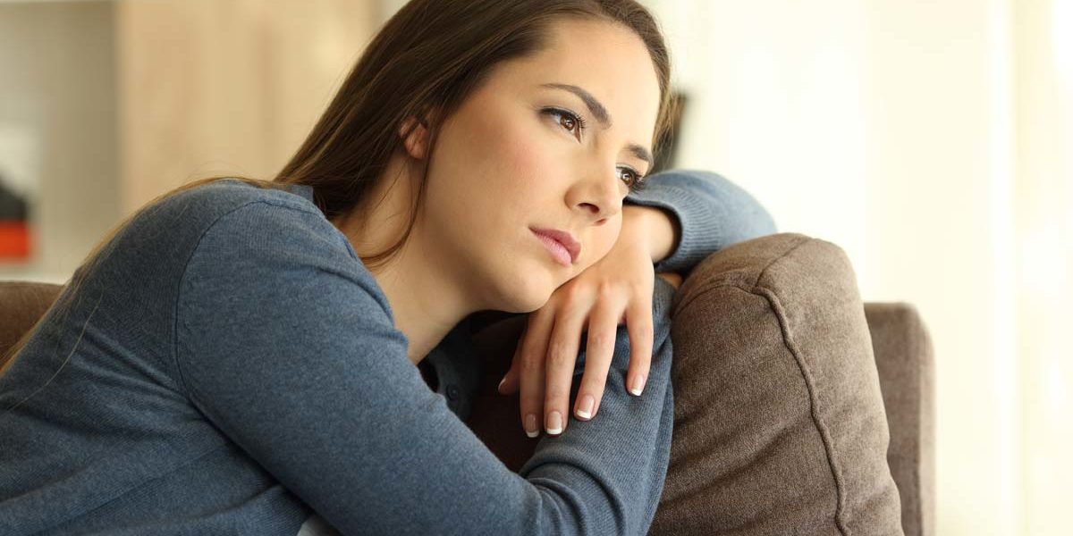 woman sitting on couch boared